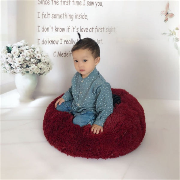 A large dog comfortably curled up in a 100cm FurryFable calming bed