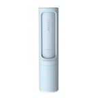 Travel-sized FurryFable pet hair brush in a car interior, removing dog hair