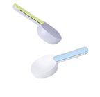 Pet food spoon in powder coffee color, resting next to a bag of dog food