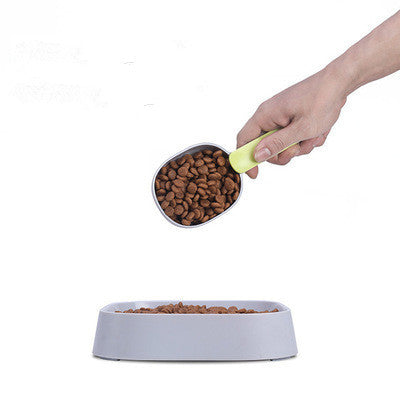 FurryFable pet food spoon being used to pour kibble into a dog bowl
