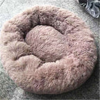 FurryFable donut bed in green, with a puppy nestled inside