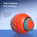 Two cats playing simultaneously with the blue and orange interactive balls.